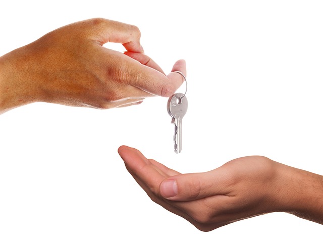person handing keys to another